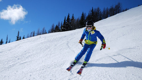 A person skiing down a snow slope in winter 