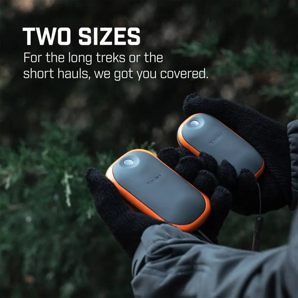 Two sizes of Thaw rechargeable hand warmer power banks being held in a persons hands