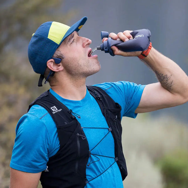 Man squeezing water in to his mouth after running using a LifeStraw Collapsible Squeeze Water Filter Bottle 650ml
