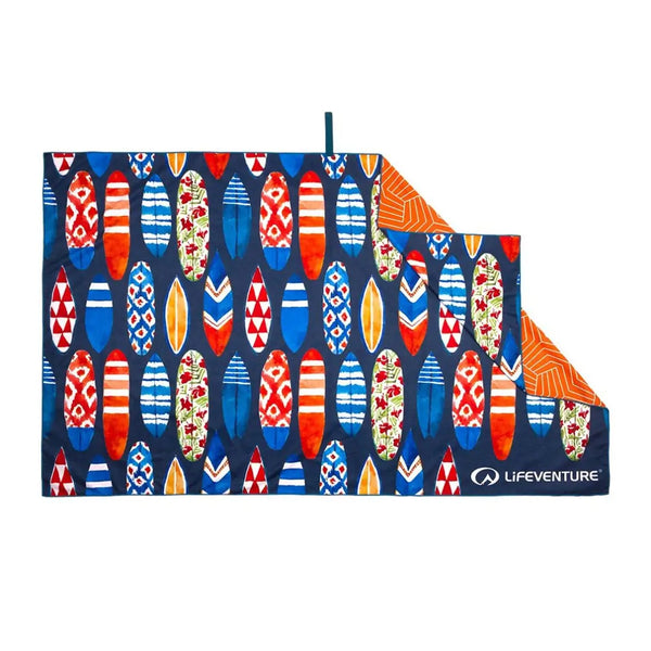 Lifeventure soft fibre travel towel in surfboard print laid out flat showing the reverse orange pattern backing
