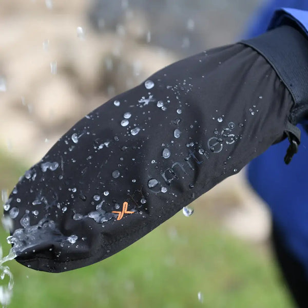 Lifestyle image of rain hitting the back of an Extremities Torrent Waterproof lightweight mitt and the water beading off