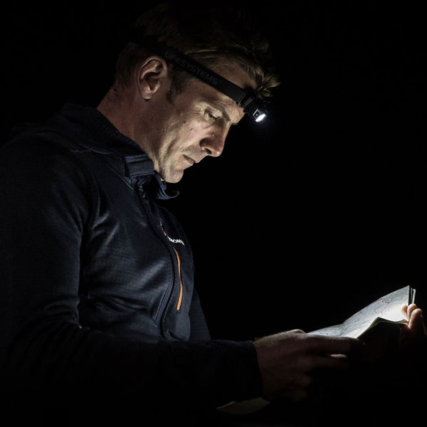 Lifesystems Intensity 155 Lumens LED Head Torch being used to read a map in the dark