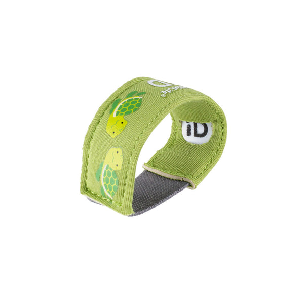 Studio shot on a white background of a Littlelife Identification wristband in the turtle pattern on its side showing the slot for the ID information card