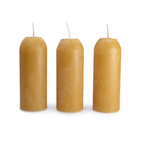 UCO 12 hour lantern natural beeswax candles in a line of three unlit